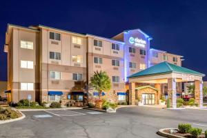 a hotel with a parking lot in front of it at Clarion Pointe Medford in Medford