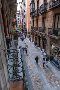 a group of people walking down a street at Espacioso Apartamento a estrenar!! Casco Viejo in Bilbao