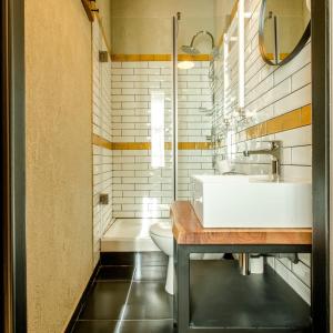 a bathroom with a sink and a toilet and a tub at ACSA INN in Craiova