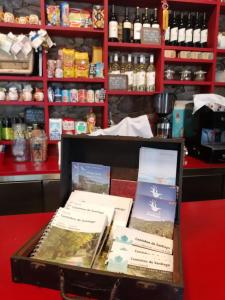 a box of books sitting on a table in a store at CASA AVÓ CATARINA Mesquita, turismo na aldeia in Espírito Santo