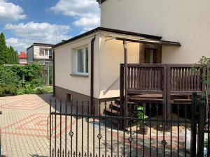 a black fence in front of a house at Mazury Apartament in Ostróda