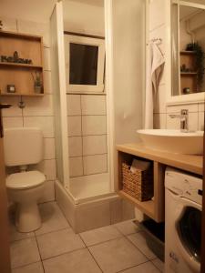 a bathroom with a toilet and a sink at Baška Voda - Apartmani Vesna in Baška Voda +14 photos