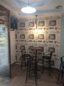 a dining room with a wall with pictures on it at Casa Turística Plaza del Conde in Ciudad-Rodrigo