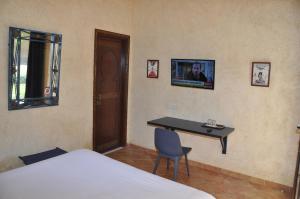 a bedroom with a desk and a bed and a table at Gite Nadia in Casablanca