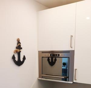 a kitchen with a stove with a nautical wall at Strandnah in Wenningstedt in Wenningstedt