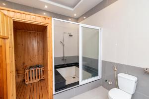 a bathroom with a shower and a toilet in it at Fusionsea Villa in Vung Tau