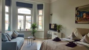 a living room with a couch and a tv at Andrés Ferienwohnung DELUXE in Cottbus