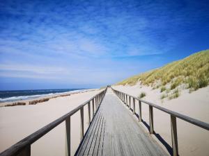 a boardwalk leading to the beach on a beach at Strandnah in Wenningstedt in Wenningstedt +10 photos