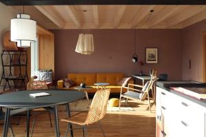 a living room with a couch and a table and chairs at Ferienwohnung Waldmeister in Sankt Peter