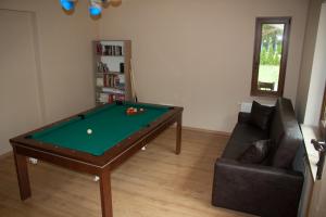 a living room with a pool table and a couch at Apartamenty Julia in Szteklin