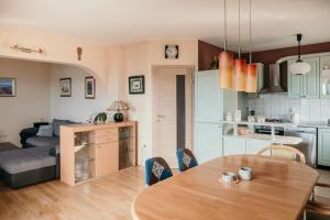 a kitchen and a living room with a wooden table at Apartments Ivana in Dramalj