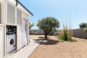 a washing machine next to a house with a tree at Living Sperlonga in Sperlonga
