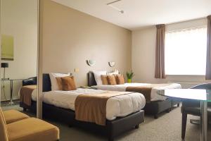 Ένα ή περισσότερα κρεβάτια σε δωμάτιο στο Hotel Adoma