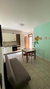 a kitchen with a table and chairs in a room at Casa Pescoluse 50m dal Mare in Marina di Pescoluse