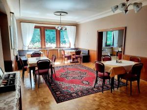 a dining room with tables and chairs and a rug at Hotel Pension Blüchersruh in Bad Berneck im Fichtelgebirge
