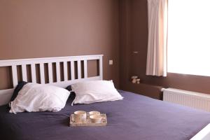 Break@Bruges tesisinde bir odada yatak veya yataklar