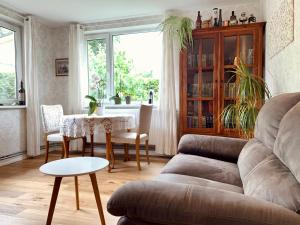 a living room with a couch and a table at Vana-Rääma Villa in Pärnu