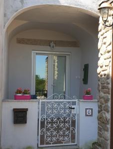 an entrance to a house with a gate and a window at Borgo Antico in Marciana Marina