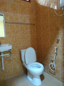 a bathroom with a toilet and a sink at Cikgu CTZ Homestay A in Kampung Raja +6 photos