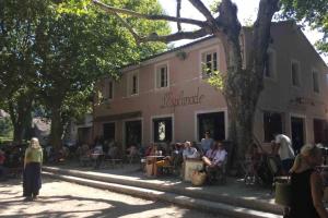 a group of people sitting outside of a building at Petit Paradis, 1 bedroom house in Sommières