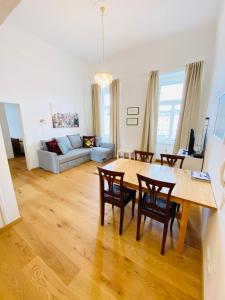 a living room with a table and chairs and a couch at Suite Marie Antoinette in Gmunden