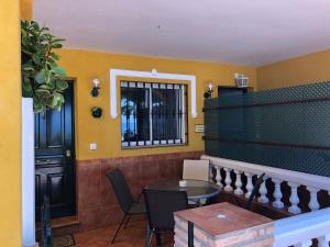 a room with a table and chairs and a window at Apartamentos casa Tia Antonia in Málaga