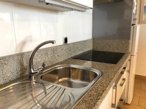a kitchen sink with a faucet on a counter at Apartamentos casa Tia Antonia in Málaga