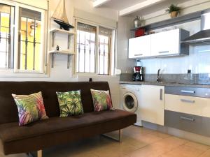 a living room with a couch in a kitchen at Apartamentos casa Tia Antonia in Málaga