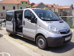 a small white van parked in a parking lot at Villa Welcome in Vrboska