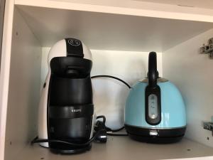 a coffee maker and a blender on a shelf at Apartamentos casa Tia Antonia in Málaga