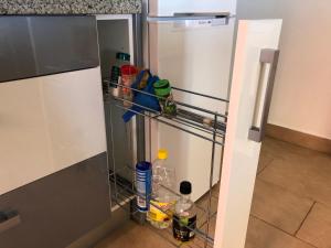 an empty refrigerator with its door open in a kitchen at Apartamentos casa Tia Antonia in Málaga