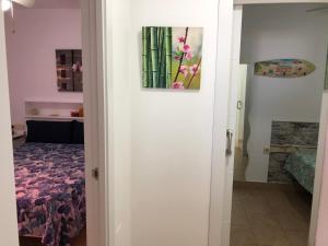 a door to a room with a bed and a picture at Apartamentos casa Tia Antonia in Málaga
