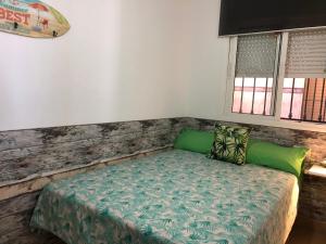 a small bed in a room with a wall at Apartamentos casa Tia Antonia in Málaga