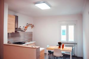 a kitchen with a table and a dining room at APPARTAMENTO TORRESI 2 in Ancona