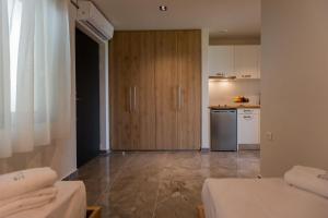 a room with a kitchen with a refrigerator and a counter at Tramonto Suites in Xi