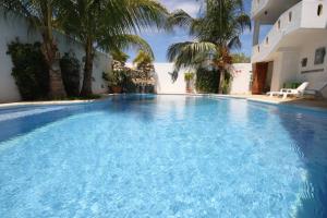 a large swimming pool with blue water in front of a building at Hotel Bahia Huatulco in Santa Cruz Huatulco