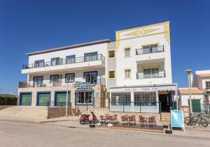 a white building with a scooter parked in front of it at Altura Beach AL2 in Altura