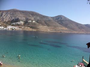 a view of a beach with people in the water at Aegeon Pension in Aegiali