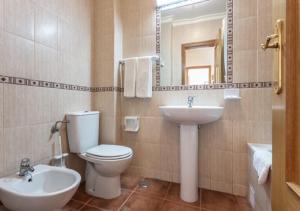 a bathroom with a toilet and a sink and a mirror at Altura Beach AL2 in Altura +13 photos