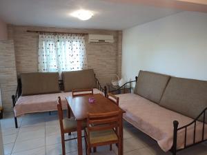 a living room with a couch and a table at Marietta's Apartments in Agios Andreas