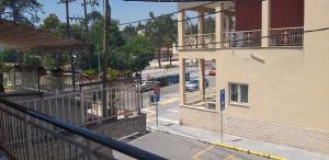 a view of a street from a balcony of a building at THE GEORGE APARTMENTS in Nea Kalikratia