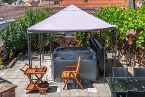 a hot tub under a tent with a table and chairs at Mikulov - Inn - hotel s vinným sklepem Venuše in Mikulov