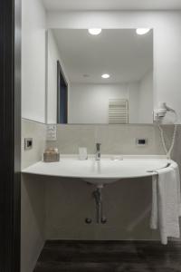 a bathroom with a white sink and a mirror at Hotel Giulietta Romeo in Lazise