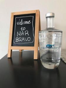 a bottle of water next to a chalkboard with a sign at Hotel Mar Bravo in Nazaré