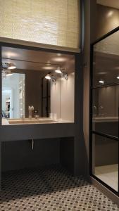 a bathroom with a sink and a mirror at Botteghelle14 suites in Salerno