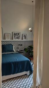 a bedroom with a bed and a table with a chair at Botteghelle14 suites in Salerno
