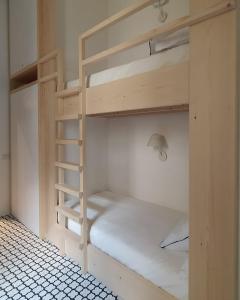 a room with two bunk beds with a ladder at Botteghelle14 suites in Salerno +10 photos