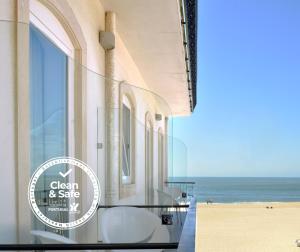 a view of the beach from a building with a table and chairs at Hotel Mar Bravo in Nazaré
