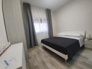 A bed or beds in a room at B&B IONIO