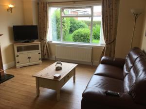 a living room with a couch and a coffee table at Crescent Corner, Inverness in Inverness